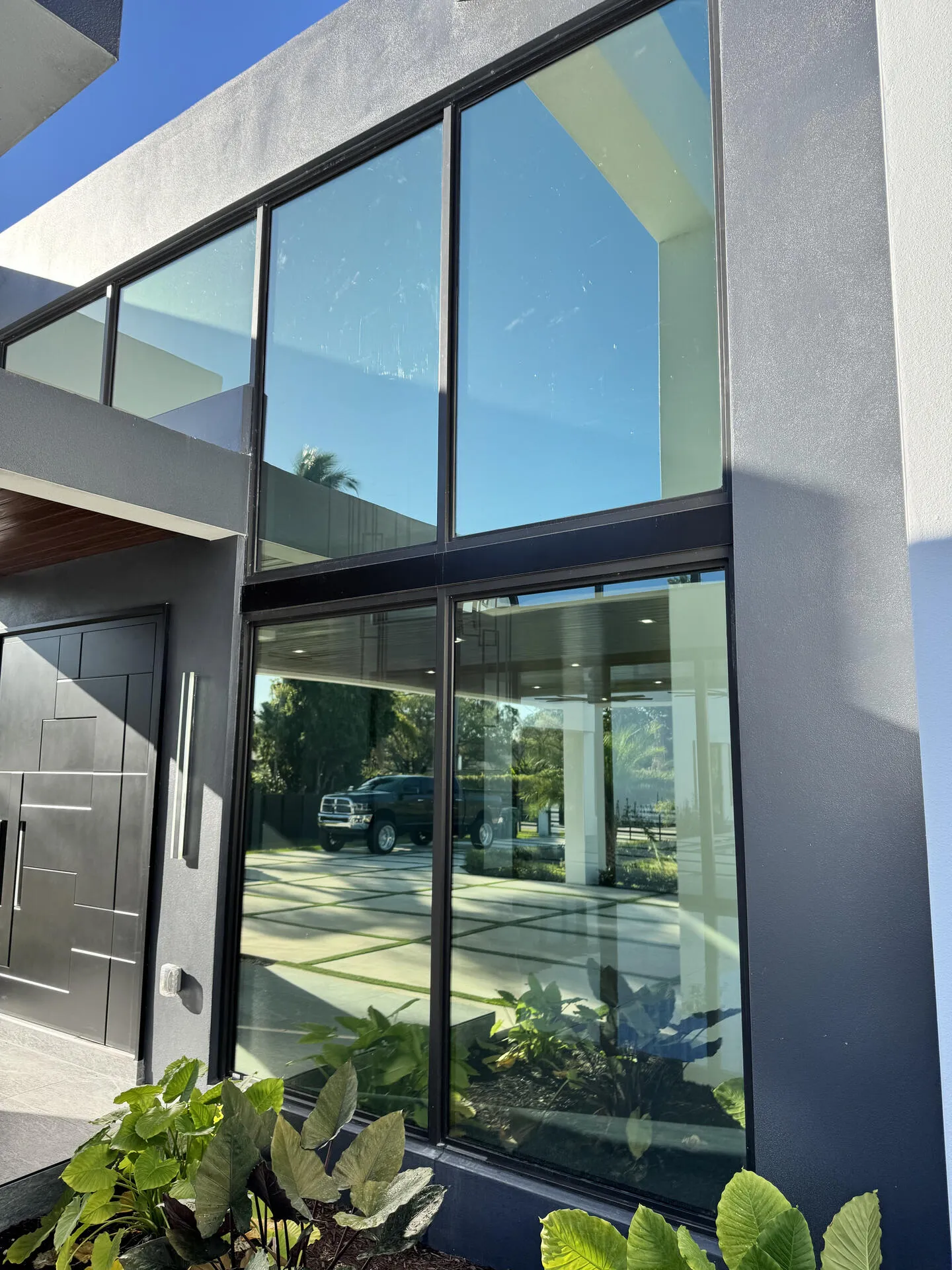 Modern home exterior with window film